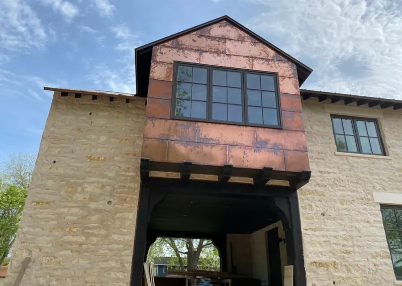 Copper metal panel facade on a stone building for Roof Repair in Leonardtown